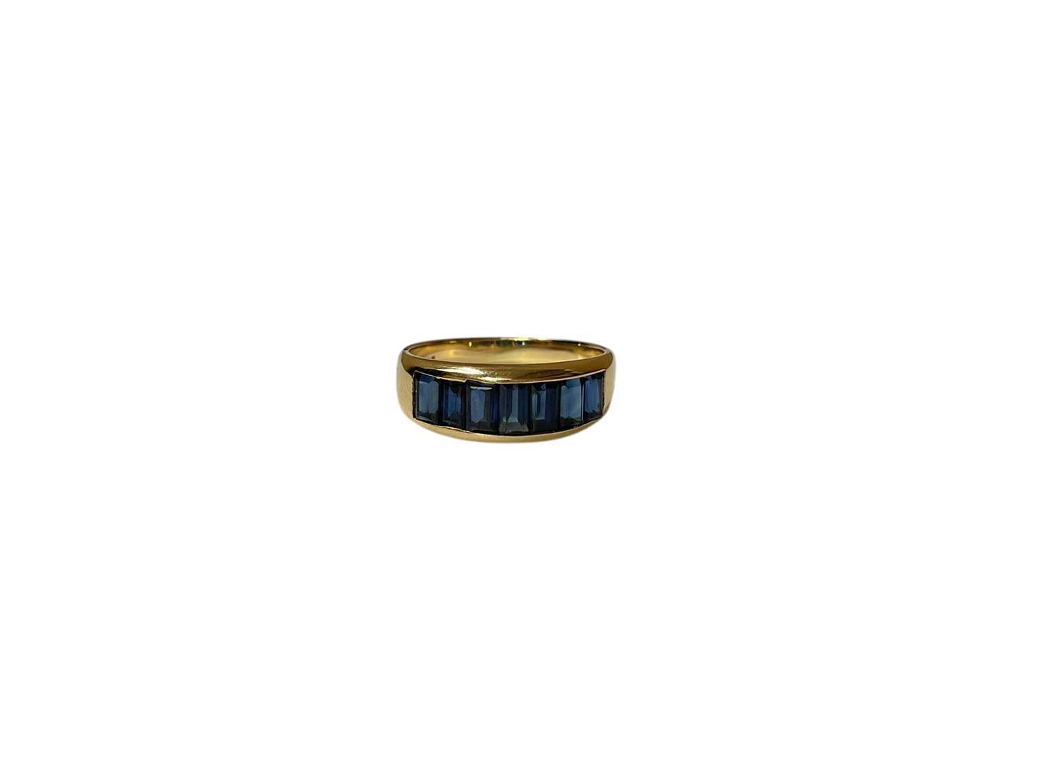 Lot 28 - 18ct gold blue sapphire seven stone ring in 18ct gold channel setting