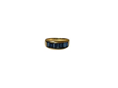 Lot 28 - 18ct gold blue sapphire seven stone ring in 18ct gold channel setting