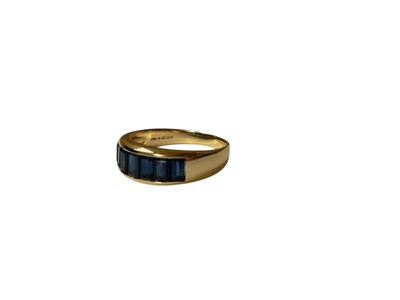 Lot 28 - 18ct gold blue sapphire seven stone ring in 18ct gold channel setting
