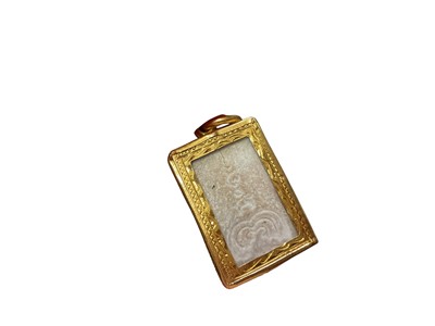 Lot 30 - Eastern religious tablet in yellow metal pendant setting, a blue stone pendant in 18ct gold setting and a 9ct rose gold Welsh love spoon pendant (3)