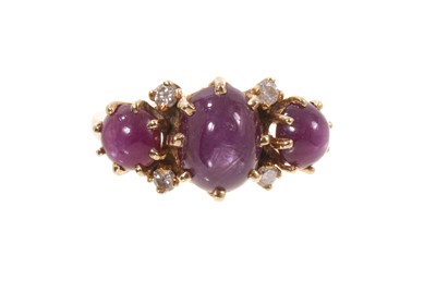 Lot 569 - Ruby and diamond ring with three oval cabochon star rubies, the largest measuring approximately 10mmx 8mm, set with four brilliant cut diamonds, all in claw setting on 14K yellow gold shank. Rin...