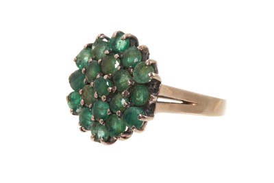 Lot 572 - Emerald cluster ring with 19 round mixed cut emeralds in tiered claw setting on 18ct white gold setting