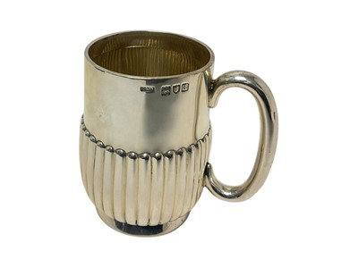 Lot 387 - Victorian silver mug of half fluted form, with plain loop handle, on a circular base