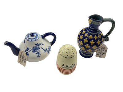 Lot 1142 - Victorian Minton majolica mask jug, together with a Blue Sunflower pattern teapot and an Art Deco sugar pot (3)