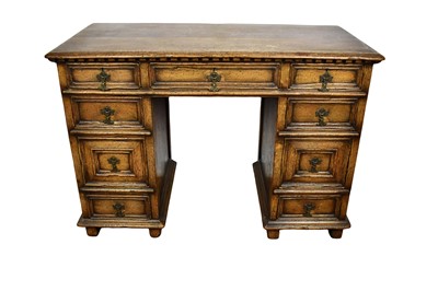 Lot 1603 - 17th century revival carved oak kneehole desk