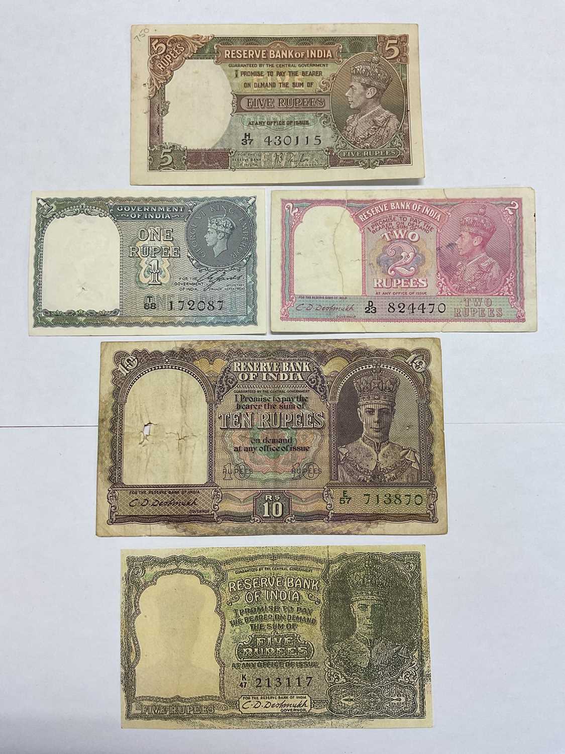 Lot 417 - India - British Raj Reserve Bank of India George VI mixed banknotes to include Obv: Facing bust types 10 Rupee C.D. Deshmukh 1943, blue-violet & olive (N.B. Holed) otherwise GF, 5 Rupee C.D....
