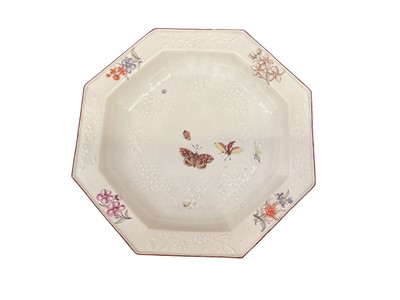 Lot 119 - Chelsea porcelain dish, circa 1756, of octagonal form, with moulded floral decoration, painted in polychrome enamels with floral sprays and insects.