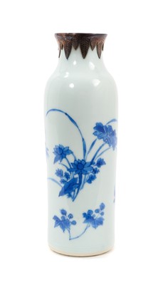 Lot 122 - A Chinese Transitional period blue and white porcelain sleeve vase, painted with flowers, with white metal mounted rim, 20.75cm high