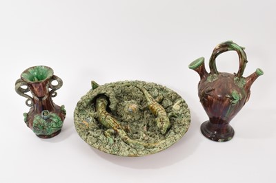 Lot 132 - Three pieces of Portuguese Palissy ware pottery, including a ewer and vase with moulded frogs and lizards on a brown ground, both by Mafra, and a dish by Jose a Cunha, 31cm diameter (3)