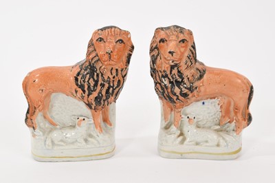 Lot 133 - A pair of early Victorian Staffordshire pottery 'Lion and Lamb' groups, pearlware glazed, on lined bases, 10cm high