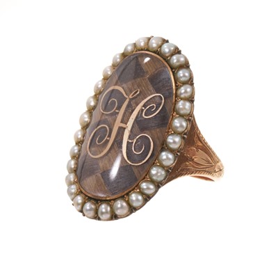 Lot 506 - George III gold and seed pearl mourning ring with a large oval glazed bezel containing a finely woven hair chequered panel surmounted by a gold initial 'H', surrounded by a seed pearl border, en...