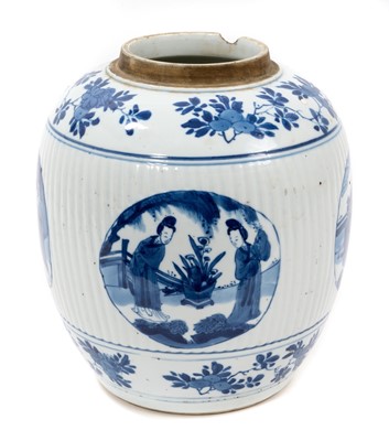 Lot 141 - A Chinese blue and white porcelain jar, Kangxi mark and period, of ribbed form, painted with round panels containing figural scenes, with floral patterned borders, 21.5cm high