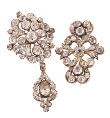 Lot 548 - Two Georgian 'black dot' paste-set pendant/brooches with silver collets and gold closed-back settings, the pendant 65mm.