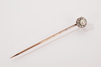 Lot 553 - Victorian diamond and pearl stick pin with a 4.25mm button pearl surrounded by ten old cut diamonds in gold claw setting
