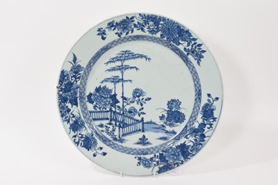 Lot 156 - 18th century Chinese blue and white export porcelain charger, painted with a landscape, with diaper border, the edge with floral sprays, 38.5cm diameter