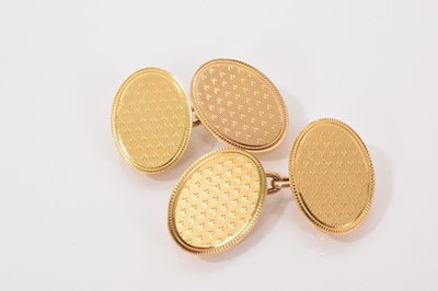 Lot 710 - Pair of 1930s 18ct gold oval panel cufflinks with engine turned decoration (Chester 1930)