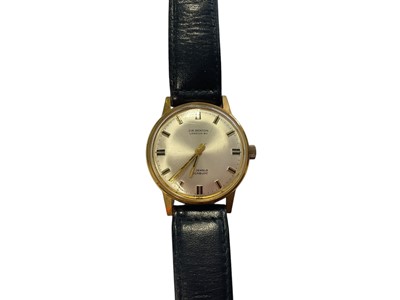 Lot 163 - 1960s J.W. Benson gold plated stainless steel wristwatch on black leather strap