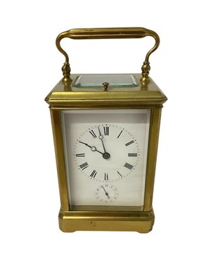 Lot 826 - Repeating alarm carriage clock in brass case with white enamel dial with bevelled glazed panels 18cm, key present
