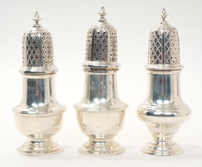 Lot 456 - Three contemporary silver casters of similar baluster form with pierced slip in covers