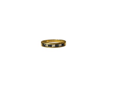 Lot 16 - 18ct gold diamond and sapphire seven stone ring in a channel setting