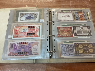 Lot 423 - Thailand - An album containing mixed banknotes to include scarcer mid 20th century issues and others (N.B. Mixed grades) (98 banknotes)