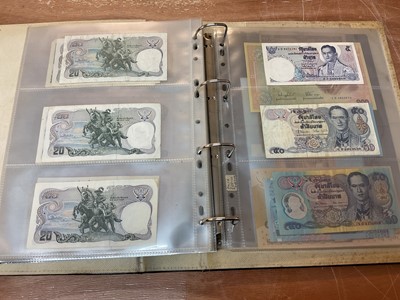 Lot 423 - Thailand - An album containing mixed banknotes to include scarcer mid 20th century issues and others (N.B. Mixed grades) (98 banknotes)