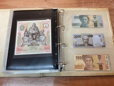 Lot 423 - Thailand - An album containing mixed banknotes to include scarcer mid 20th century issues and others (N.B. Mixed grades) (98 banknotes)
