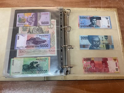 Lot 423 - Thailand - An album containing mixed banknotes to include scarcer mid 20th century issues and others (N.B. Mixed grades) (98 banknotes)