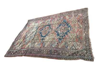 Lot 1737 - Heriz carpet, with three stepped medallions on brick red ground in multiple borders, 310 x 231cm