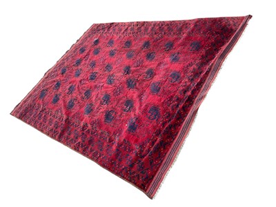 Lot 1738 - Tekke type rug, with three rows of five quartered medallions on claret ground