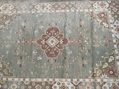 Lot 1740 - Turkish rug with geometric design on pale green ground, 280cm x 180cm
