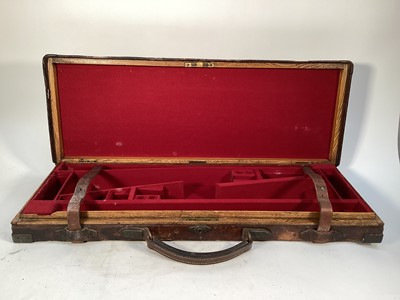 Lot 1195 - Late Victorian/Edwardian brass mounted leather and oak double gun case with fitted interior, 31cm x 85cm