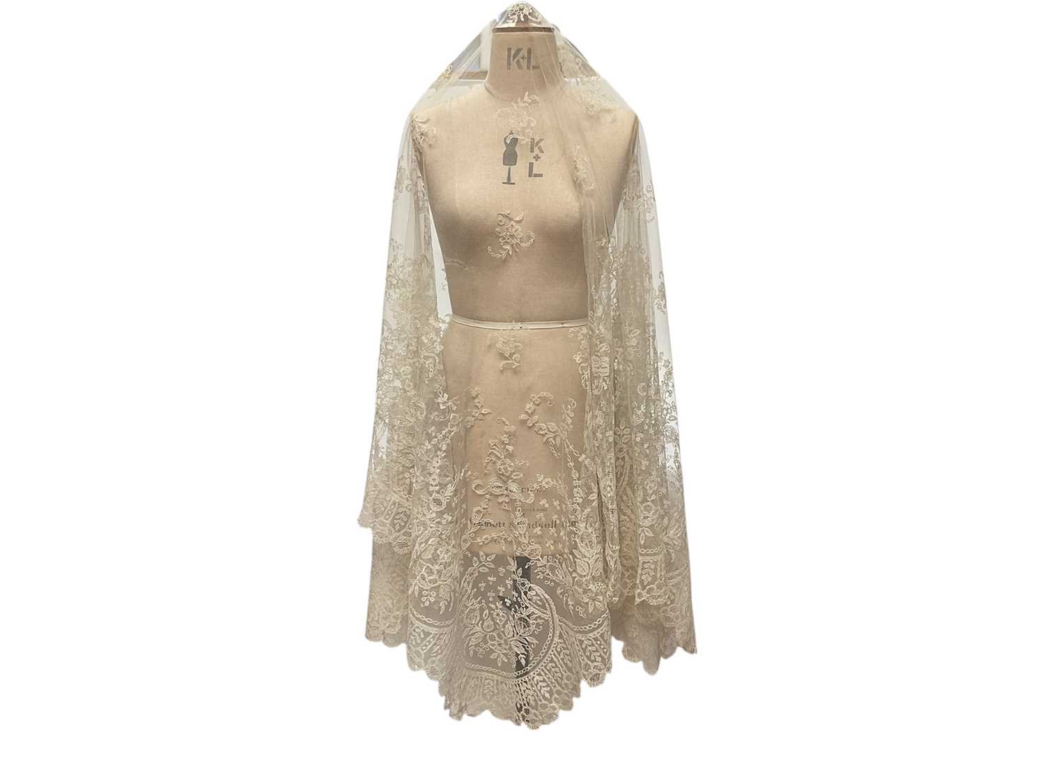 Lot 2053 - Fine 19th century Brussels lace wedding veil, worked with tulips, roses, bows etc and scalloped edge.