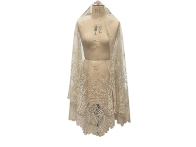 Lot 2053 - Fine 19th century Brussels lace wedding veil, worked with tulips, roses, bows etc and scalloped edge.