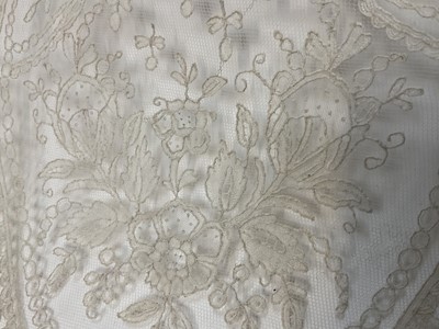 Lot 2053 - Fine 19th century Brussels lace wedding veil, worked with tulips, roses, bows etc and scalloped edge.