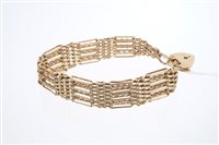 Lot 628 - Gold (9ct) gate bracelet with seven bar links...