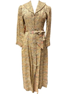 Lot 2064 - Vintage Chinese long, fitted dressing gown with quilted collar and padded shoulder seams, garden scenes on a gold ground. Loop and knot fastenings. Plus a mid century Chinese red and blue rev...