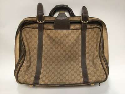Lot 2095 - Vintage luggage Gucci canvas travel bag with leather straps and handle.