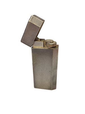 Lot 136 - Cartier 'Must de Cartier' white metal lighter with engine turned decoration, numbered 82916S.