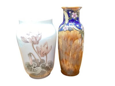 Lot 1173 - Royal Copenhagen vase decorated with flowers, 25.5cm high, together with a Royal Doulton stoneware vase, 29.5cm high (2)
