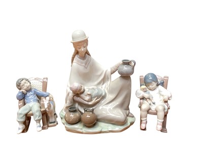 Lot 1175 - Three Lladro porcelain figures including Peruvian girl with baby, 23.5cm high, All Tuckered Out and Naptime, all boxed