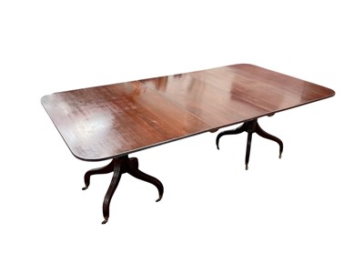 Lot 1543 - Regency-style twin pedestal dining table with extra leaf, with turned and bulbous column supports on four splayed receded legs terminating on brass cap castors, 211cm long x 113.5cm wide