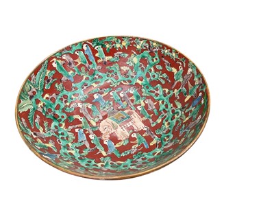 Lot 763 - Japanese early to mid 19th century Edo period pottery bowl decorated in the manner of Aoki Mokubei, with an elephant surrounded by many figures on a red ground, seal mark to base