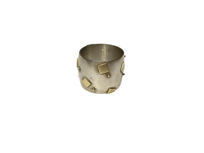 Lot 117 - Modernist silver thick band ring with applied yellow metal square and dot decoration (Dublin 2000)