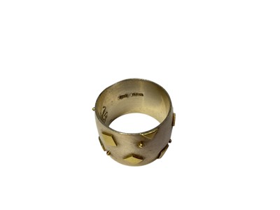 Lot 117 - Modernist silver thick band ring with applied yellow metal square and dot decoration (Dublin 2000)