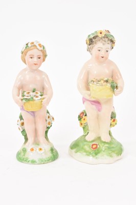Lot 156 - 18th century Derby porcelain figure of a child holding a basket of flowers, together with a similar continetal copy (2).