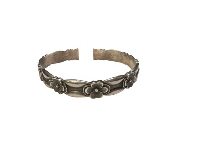 Lot 99 - Chinese silver torque bangle with flower head decoration