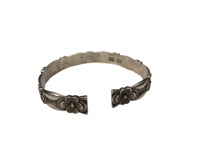 Lot 99 - Chinese silver torque bangle with flower head decoration