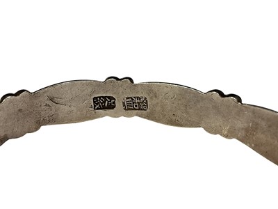 Lot 99 - Chinese silver torque bangle with flower head decoration