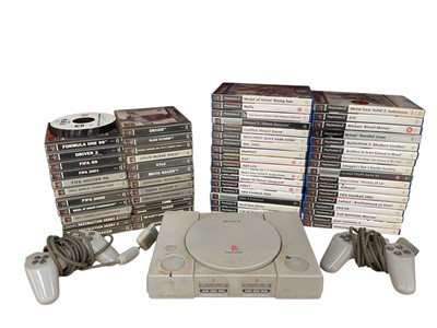 Lot 1989 - Sony PlayStation 1 with approximately 20 games and two controllers together with boxed Sony PlayStation 2 with approximately 30 games and four controllers